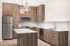 Kitchen with wood cabinets and stainless steel appliances at Sonora in Austin, TX