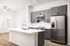 Kitchen with gray cabinets, stainless appliances and island at Sonora in Austin, TX