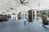 Modern gym with state-of-the-art equipment, featuring weight machines, treadmills, and exercise bikes in a spacious, light-filled setting.