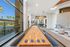 Luxury clubhouse with a shuffleboard table, modern lounge seating, and poolside views, perfect for entertainment and relaxation.