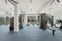 Bright, modern gym with state-of-the-art fitness equipment, large windows, and sleek design for an energizing workout experience.