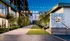 Chic courtyard view at dusk with modern architectural design, ambient lighting, and lush greenery at The Row.