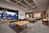 Luxurious open-concept living space featuring a stylish game room with ping pong table, modern dining area, cozy seating by the fireplace, and an inviting outdoor patio with pool view.