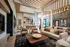 Sophisticated lounge area with modern decor, featuring luxurious seating, stylish wooden accents, and large windows offering natural light.