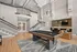 Luxurious resident lounge featuring an elegant pool table, modern bar setup, and a cozy seating arrangement under stylish pendant lighting.
