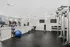 Bright, modern fitness center featuring cardio machines, strength training equipment, and a sleek, minimalist design.