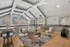 Elegant loft space with vaulted ceilings, chic modern seating, and abundant natural light through large windows.
