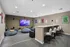 Chic entertainment room with cozy bean bags, stylish bar seating, and a large flatscreen TV, perfect for relaxing and socializing.