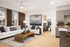 Contemporary living area with sleek white sofa, elegant decor, and cozy bedroom in view, adjacent to a modern kitchen with stylish cabinetry.