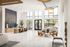 Luxurious apartment lobby with high ceilings, elegant seating, and large windows offering abundant natural light.