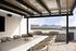 Luxurious outdoor patio with stylish seating, modern grill, and stunning mountain views.