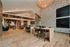 Luxurious open-concept living space with elegant wooden flooring, modern furniture, and a stunning chandelier.