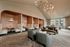 Chic apartment lounge with elegant seating, stylish pendant lights, and warm natural lighting.