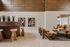 Elegant lounge area featuring modern stools, artistic wall decor, and cozy seating with a contemporary vibe.