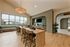 Elegant and spacious community lounge featuring modern wood furniture, large windows with a scenic view, and a stunning chandelier centerpiece.