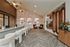 Elegant interior featuring a modern reception area with stylish seating, chic wall art, and warm lighting.