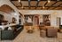Luxurious open living space with modern leather and fabric seating, artistic wall designs, and sophisticated lighting.