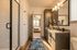 Elegant bathroom with granite countertop, modern fixtures, and glass shower, leading to a cozy bedroom.