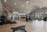 Modern fitness center with state-of-the-art gym equipment, high ceilings, and abundant natural light.