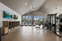 Sleek and modern gym with state-of-the-art fitness equipment and large windows offering natural light.