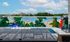 Vibrant rooftop mural above a luxurious swimming pool, showcasing a serene blend of art and outdoor ambiance.