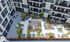 Modern apartment complex featuring a beautifully landscaped courtyard with seating areas, garden planters, and contemporary design.