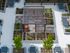 Modern rooftop garden with sleek dining areas, lush planters, and a stylish pergola, perfect for urban relaxation.