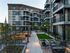 Modern apartment complex with stylish architecture, inviting outdoor seating, and lush landscaped courtyards.