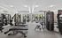 Modern fitness center with state-of-the-art equipment and large windows inviting natural light.
