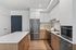 Chic modern kitchen with elegant white cabinetry, sleek stainless steel appliances, and a spacious marble-topped island.