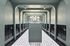Elegant, modern mailbox hallway with stylish archways and chic lighting, perfect for a sophisticated residential building.