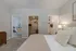 Inviting bedroom with direct access to a cozy living room, spacious walk-in closet, and elegant bathroom.