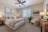 Elegant bedroom featuring a plush bed with cozy pillows, contemporary decor, and warm lighting for a relaxing ambiance.