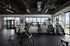 Modern fitness center with high-end gym equipment, large windows offering mountain views, and sleek design.