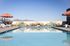 Chic rooftop pool with artistic wall mural and scenic mountain views, perfect for relaxation and sunbathing.