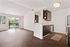 Bright, airy apartment with hardwood floors, modern kitchen, and balcony with lush views.