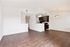 Contemporary open-plan kitchen and living area with elegant dark wood flooring and modern fixtures.