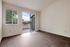 Bright and airy apartment bedroom with modern flooring, large windows, and patio access offering stunning views.
