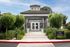 Welcoming entrance of La Vina Apartments leasing office, featuring lush landscaping and modern architecture.