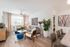 Bright and modern living room with stylish furnishings, vibrant artwork, and trendy decor, offering a cozy and inviting atmosphere.