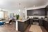 Inviting open-concept kitchen and living room with modern finishes, stylish decor, and abundant natural light.