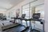 Contemporary fitness center with state-of-the-art treadmills facing bright windows, showcasing a vibrant and energetic workout space.