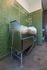 Modern pet wash station with stainless steel tub and quirky wall art offers convenience and style.