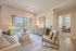Inviting living room with modern decor and balcony access, offering a bright, serene view and contemporary elegance.