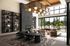 Contemporary open-concept lounge featuring elegant dining table, stylish shelving, and expansive windows with lush greenery views.
