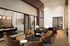 Elegant modern living space featuring plush seating, stylish decor, and a cozy dining area with warm lighting.