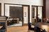 Sophisticated office space with sleek glass partitions, elegant desk setups, and plush seating, exuding modern professionalism.