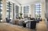 Luxurious modern apartment living area with floor-to-ceiling windows, plush seating, and elegant decor, offering stunning city views.