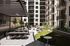 Chic urban courtyard with stylish outdoor seating, modern pergola, and lush greenery, perfect for relaxation and social gatherings.