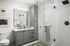 Elegant bathroom featuring modern glass shower, chic gray cabinetry, and stylish artwork.